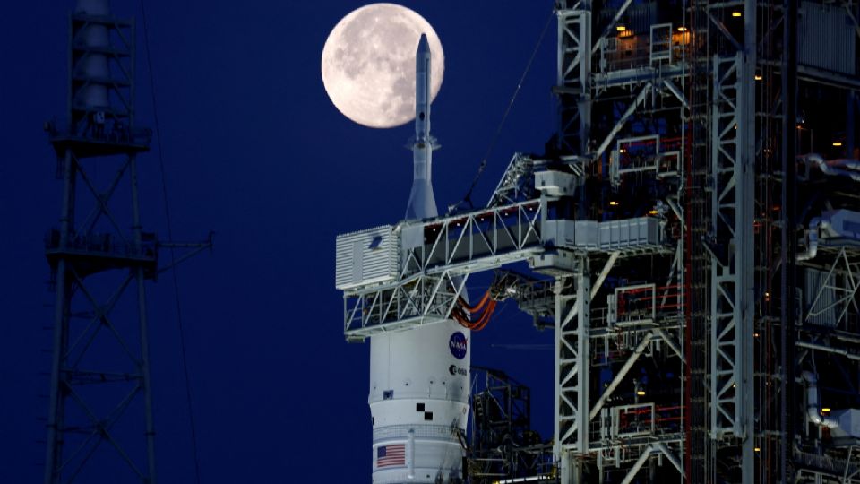 Una luna llena, conocida como la 'Luna de fresa' se muestra con el cohete lunar de próxima generación de la NASA, el Sistema de Lanzamiento Espacial (SLS) Artemis 1, en el Centro Espacial Kennedy en Cabo Cañaveral, Florida, Estados Unidos. 15 de junio de 2022.