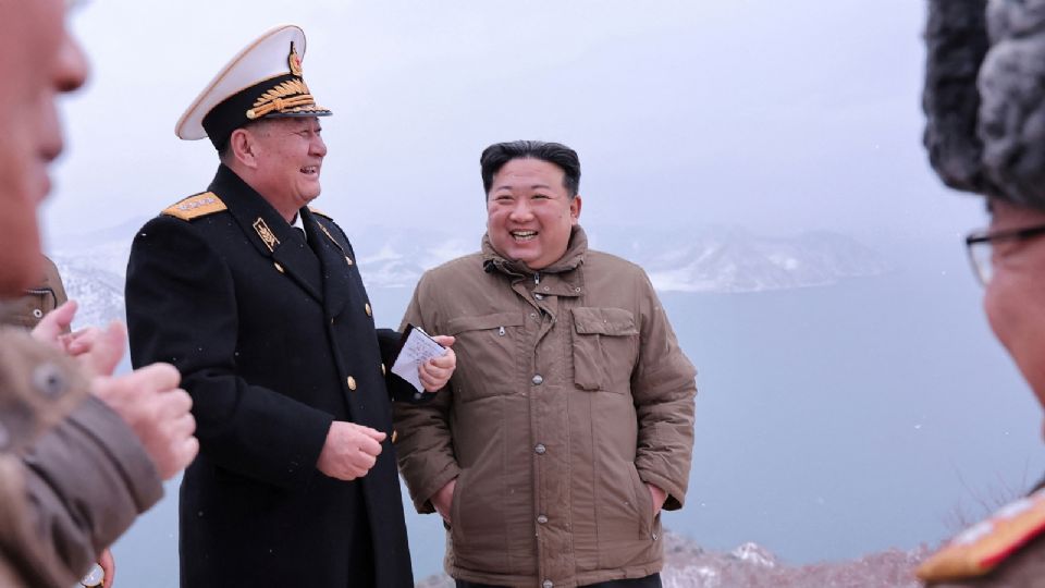 El líder norcoreano Kim Jong Un asiste a la prueba de lanzamiento de misiles de cruceros desde submarinos mientras habla con altos cargos militares en un lugar no especificado de Corea del Norte.