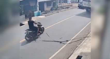 VIDEO | Motociclista es atrapado por cable suelto en la calle