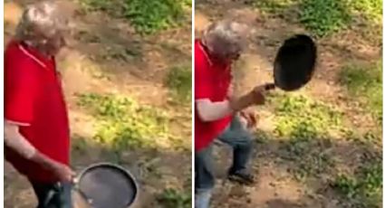 Hombre enfrenta a un cocodrilo con su sartén y se vuelve viral: VIDEO