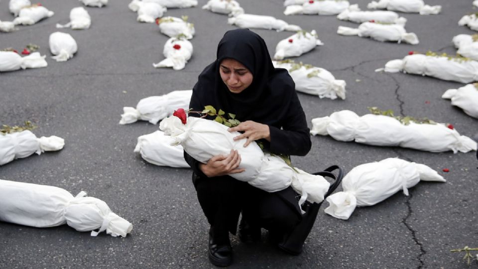 Una mujer iraní llora ante un cadáver simulado, exhibido en homenaje a los niños que murieron en medio del conflicto entre Israel y Hamas.