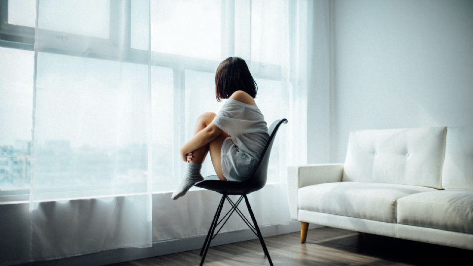 Mujer sentada frente a ventana / Ilustración