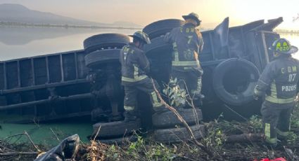 Autobús de pasajeros impacta a tractocamión y lo proyecta hacia la laguna de Xico