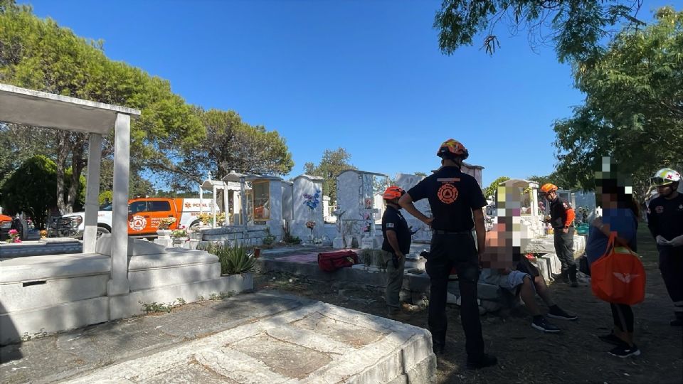 Protección Civil de Nuevo León y personal municipal atienden a un hombre que cayó en una tumba fracturada en el Panteón La Paz.