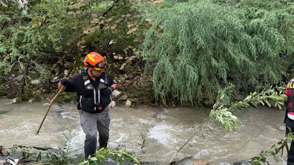 Protección Civil de Nuevo León realiza labores de búsqueda río abajo tras el arrastre de vehículos en Monterrey.